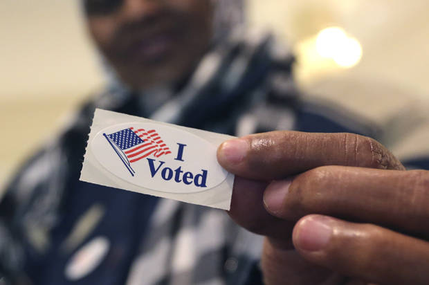 Addey Munye, 67, shows off her "I Voted" sticker after she cast her ballot in her first election at a polling station in the West Acres Mall in Fargo, N.D, Tuesday, Nov. 6, 2012. (Photo credit: AP Photo/LM Otero)