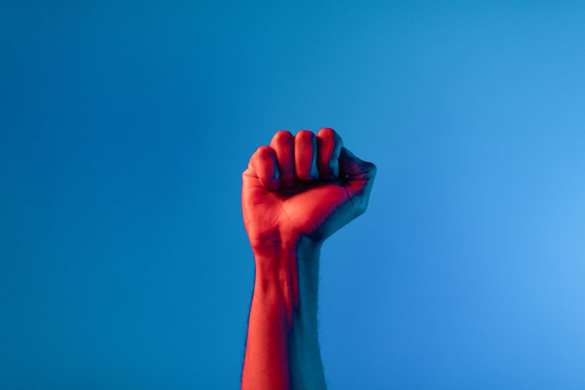 persons fist up in blue background