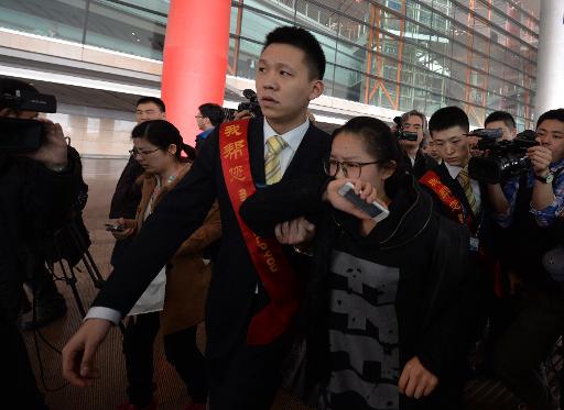 Family of a missing passenger is escorted to a waiting area for family in Beijing. (Photo credit: AFP / Mark Ralston)