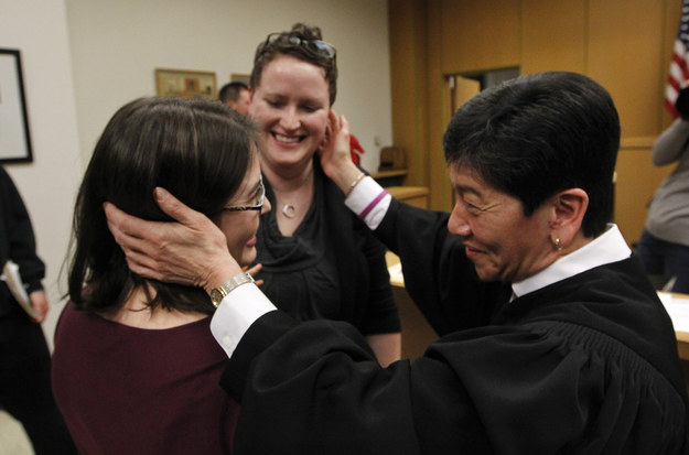 Yu officiates the marriage of Emily (left) and Sarah Coffer on December 9, 2012. (Photo credit: AP / Elaine Thompson)