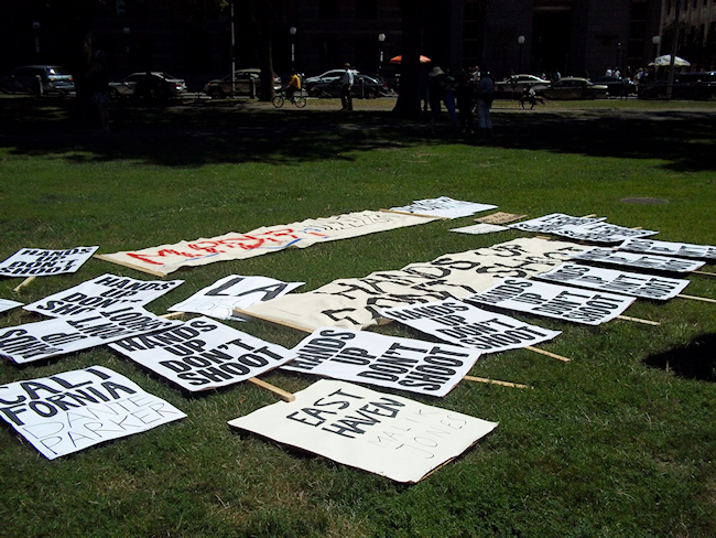 Signs on the ground, marking the site of the protest. (Photo credit: Reappropriate)