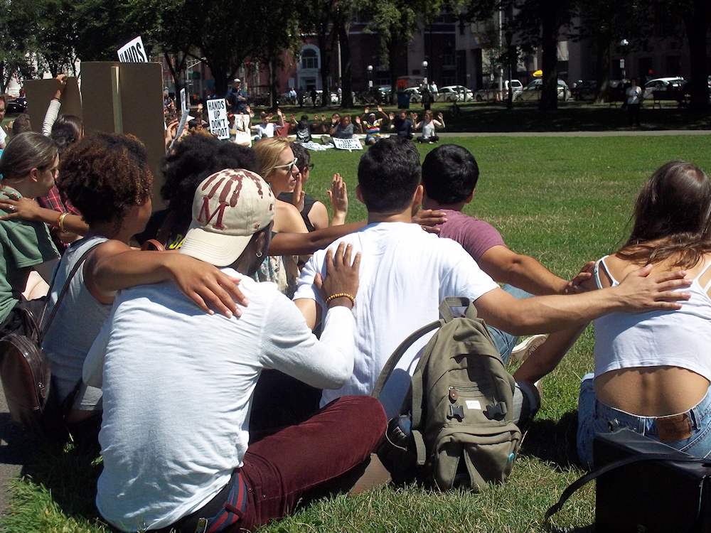Approximately 200 students and New Haven residents gather on the New Haven Green for an August 19th peaceful protest in solidarity with the residents of Ferguson. (Photo credit: Reappropriate)