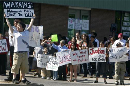 Protesters stage a street protest in 2009 in response to the shooting death of Hmong American youth Fong Lee.