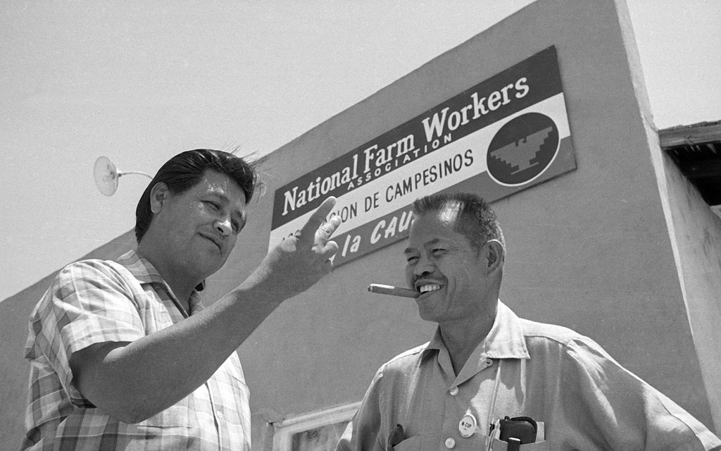 Larry Itliong stands alongside Cesary Chavez in front of NFWA headquarters in July 28, 1967. (Photo credit: AP Photo/ Harold Filan)