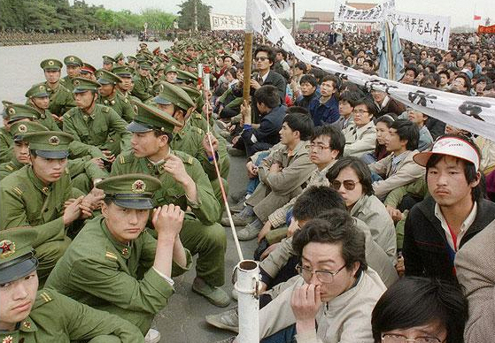 College-aged pro-democracy protesters defy police at Tiananmen in 1989. (Photo credit: AFP) 