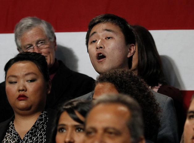 Immigration rights activist Ju Hong heckles the president, demanding action on immigration reform.