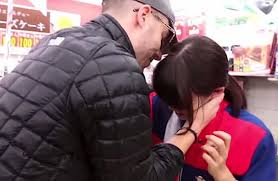 A screen-grab from a video where Julien Blanc demonstrates the "tactic" of choking a girl to assert social and sexual dominance.