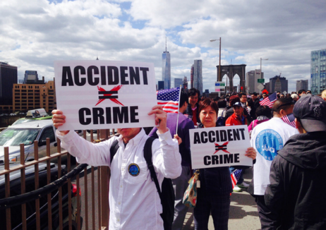 Protesters march across the Brooklyn Bridge protesting the indictment of NYPD officer Peter Liang, who fatally shot unarmed civilian Akai Gurley in November 2014. (Photo credit: Tom Miuccio / PIX11News)
