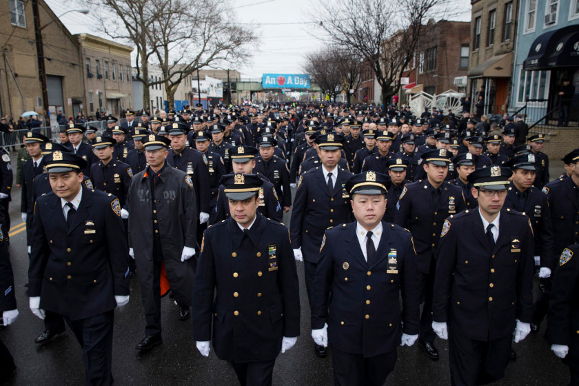 Police officers arrive to the funeral of New York Police Department Officer Wenjian Liu at Aievoli Funeral Home, Sunday, Jan. 4, 2015, in the Brooklyn borough of New York. (Photo credit: AP Photo/John Minchillo)