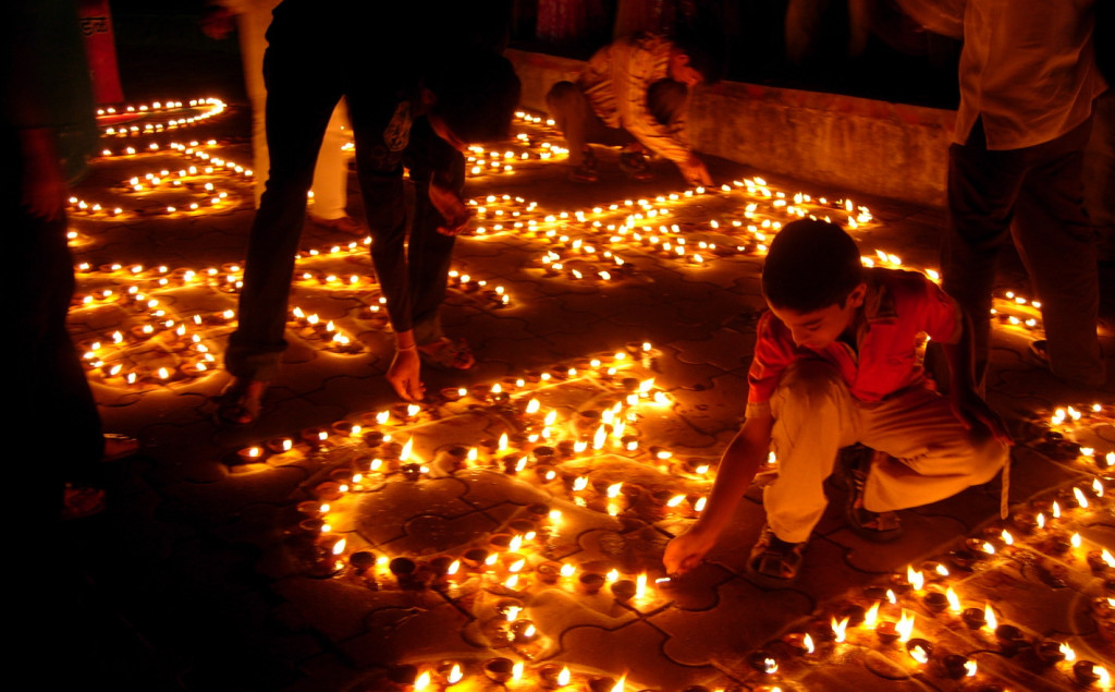 A child lights candles during Diwali, or the "Festival of Lights". 