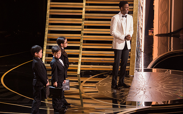 Chris Rock introduces three young Asian/Asian American children at Oscars 2016. (Photo credit: Rex)