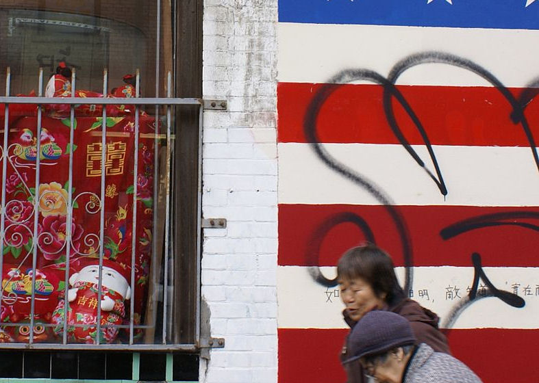 Pedestrians walk by a mural of the American flag in San Francisco’s Chinatown in February 2007. (Photo credit: Wikimedia Commons)