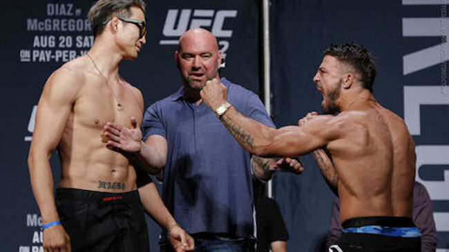 Hyun Guy Lim (left) faces off against Mike Perry (right) at their pre-fight weigh-in earlier this month. 