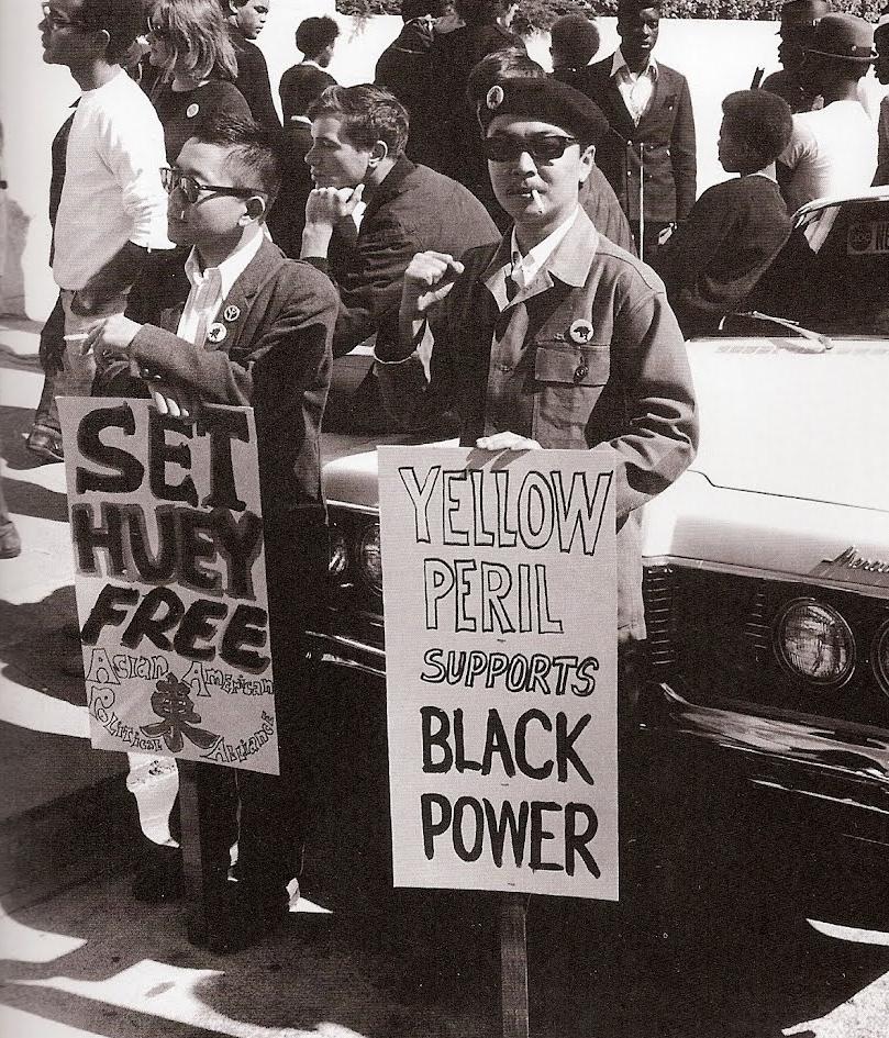 Richard Aoki, in a now famous image, holds a sign reading"Yellow Peril Support Black Power." (Photo Credit: Unknown)
