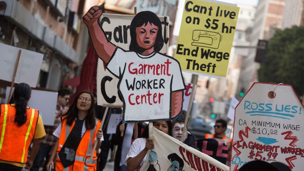 Garment workers rally in front of a Ross store on Broadway in downtown L.A. to demand an end to wage theft and unsafe working conditions on Oct. 25, 2016. (Los Angeles Times)
